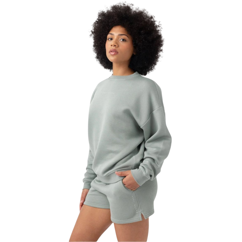 Haze CityScape Pullover Crew. The Pullover is being worn by a female model. Accompanying city scape clothing is being worn to complete the look of the outfit. The photo was taken with a white background. |Color:Haze