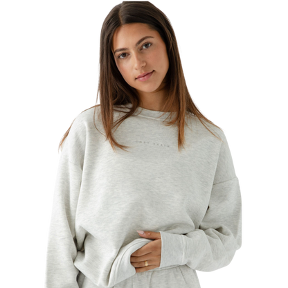 Heather Grey CityScape Pullover Crew. The Pullover is being worn by a female model. Accompanying city scape clothing is being worn to complete the look of the outfit. The photo was taken with a white background. |Color:Heather Grey