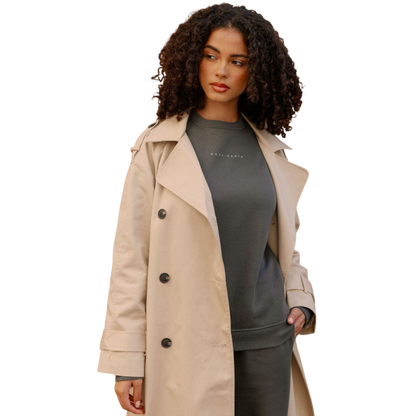 A person with curly hair models the Cozy Earth Women's CityScape Crewneck and matching pants in light pink against a plain white backdrop. |Color:Peony