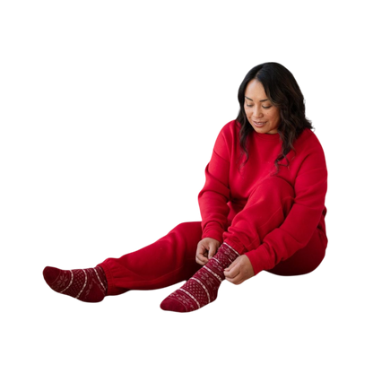 A person with curly hair models the Cozy Earth Women's CityScape Crewneck and matching pants in light pink against a plain white backdrop. |Color:Peony