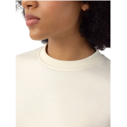 A person with curly hair models the Cozy Earth Women's CityScape Crewneck and matching pants in light pink against a plain white backdrop. |Color:Peony