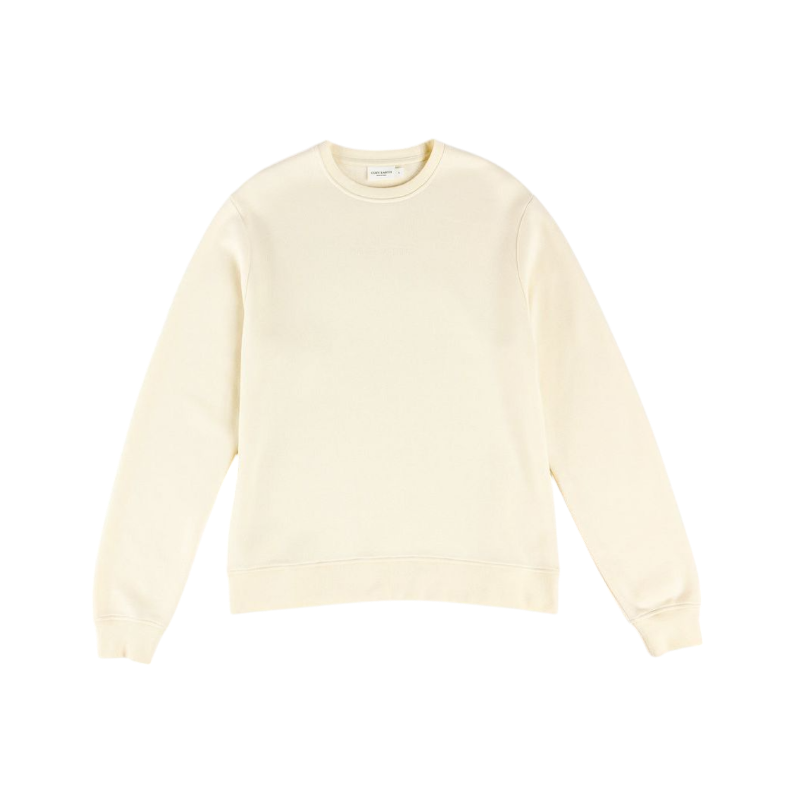 A person with curly hair models the Cozy Earth Women's CityScape Crewneck and matching pants in light pink against a plain white backdrop. |Color:Peony