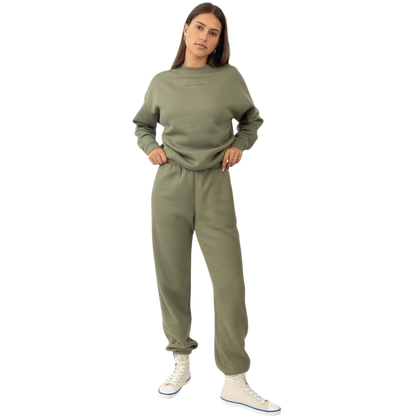 A person with curly hair models the Cozy Earth Women's CityScape Crewneck and matching pants in light pink against a plain white backdrop. |Color:Peony