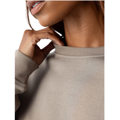 A person with curly hair models the Cozy Earth Women's CityScape Crewneck and matching pants in light pink against a plain white backdrop. |Color:Peony