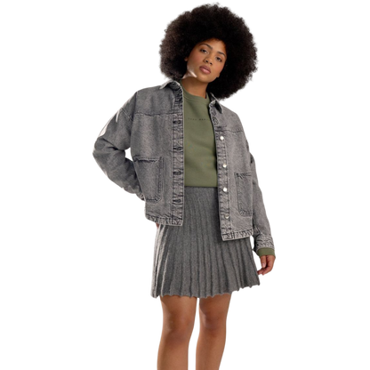 A person with curly hair models the Cozy Earth Women's CityScape Crewneck and matching pants in light pink against a plain white backdrop. |Color:Peony
