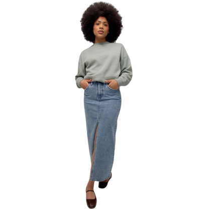 A person with curly hair models the Cozy Earth Women's CityScape Crewneck and matching pants in light pink against a plain white backdrop. |Color:Peony