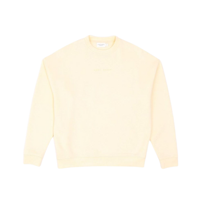 A person with curly hair models the Cozy Earth Women's CityScape Crewneck and matching pants in light pink against a plain white backdrop. |Color:Peony