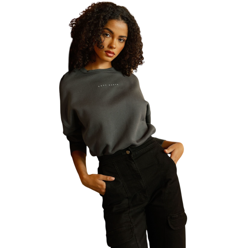 A person with curly hair models the Cozy Earth Women's CityScape Crewneck and matching pants in light pink against a plain white backdrop. |Color:Peony