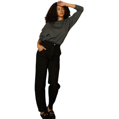 A person with curly hair models the Cozy Earth Women's CityScape Crewneck and matching pants in light pink against a plain white backdrop. |Color:Peony