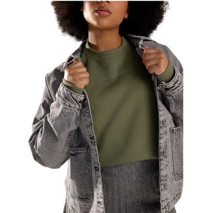 A person with curly hair models the Cozy Earth Women's CityScape Crewneck and matching pants in light pink against a plain white backdrop. |Color:Peony