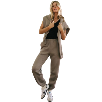 A person with curly hair models the Cozy Earth Women's CityScape Crewneck and matching pants in light pink against a plain white backdrop. |Color:Peony